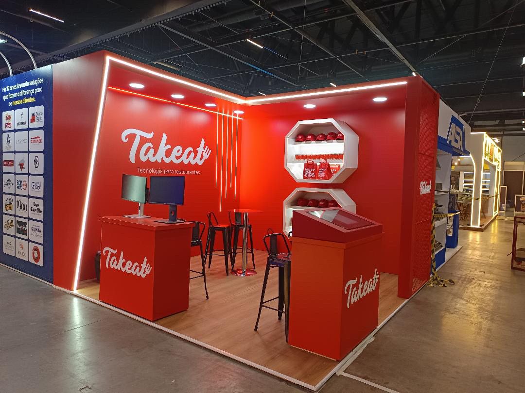 Estande vermelho da Takeat na Fispal Food Service, com logo retroiluminada e nichos octogonais de produto